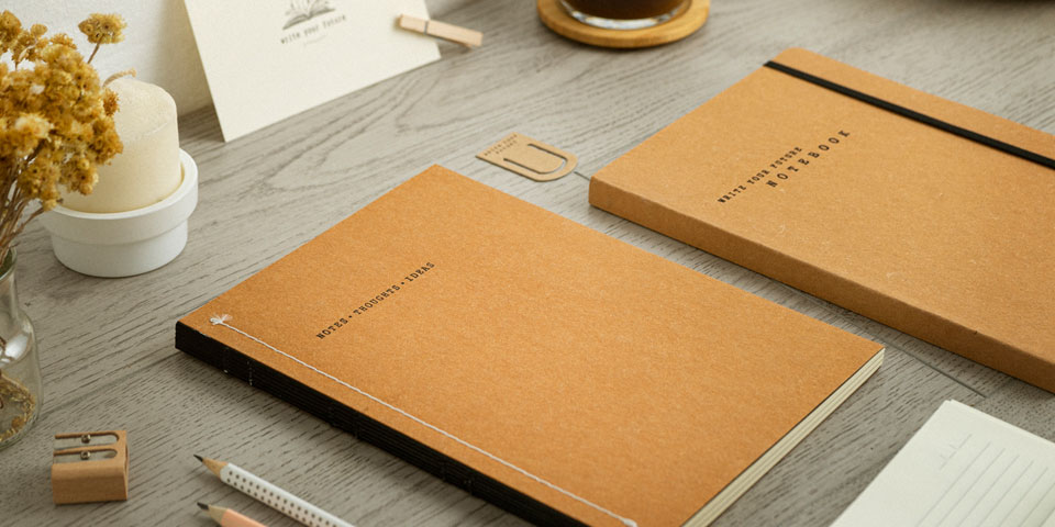 closed eco-friendly notebooks on a desk